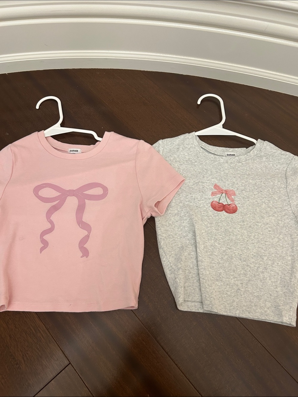 Garage cropped baby tees. One pink with a bow and one grey with cherries and bow